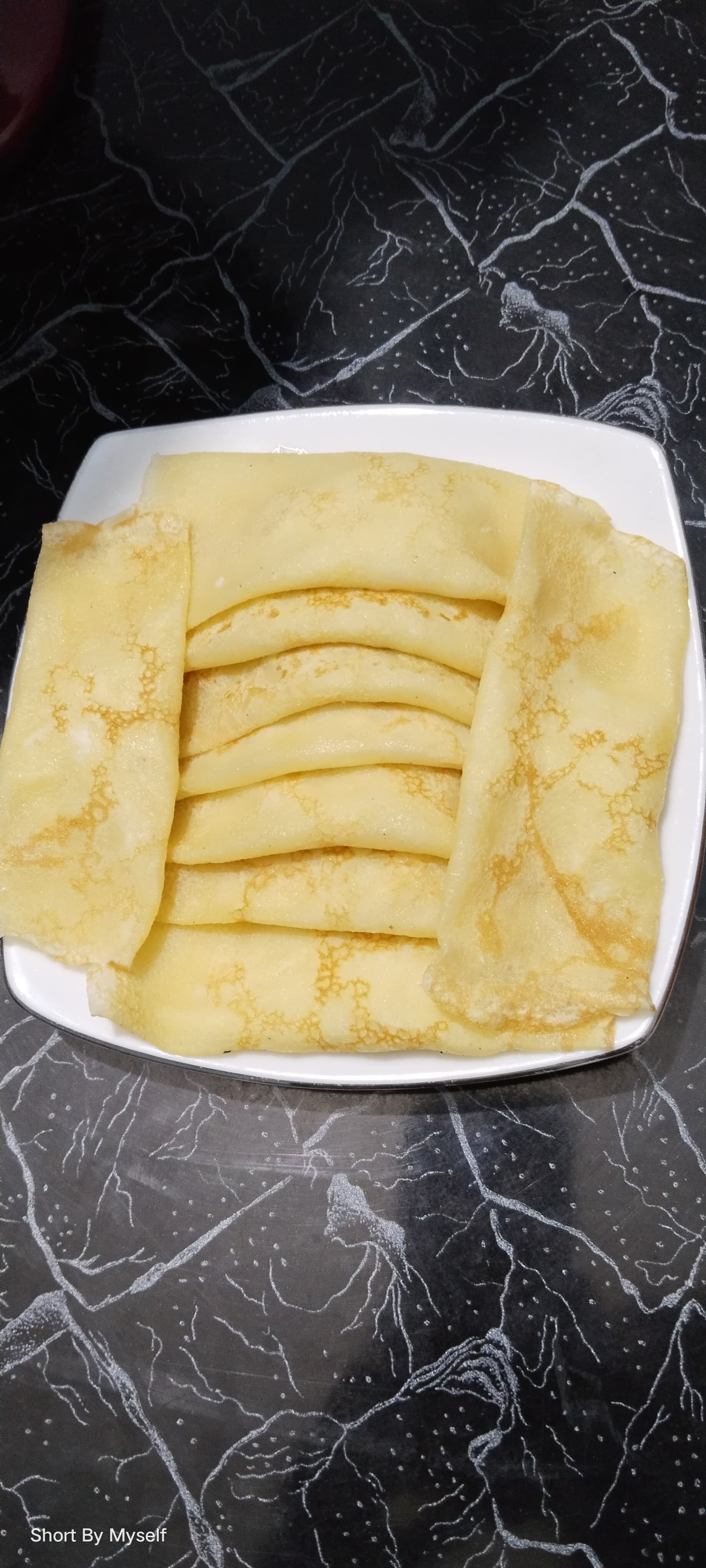 Patishapta is an extremely popular and traditional winter pitha (rice cake) or snack of Bengal. This delicious snack is prepared by making a thin batter of rice flour and all-purpose flour, frying it on a griddle like a crispy or soft flatbread, and wrapping it with a sweet filling inside.